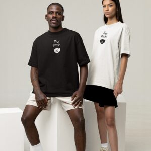 Mockup of a man and a woman wearing 'The Pooch World Tour' tee with customizable sleeves at a studio.