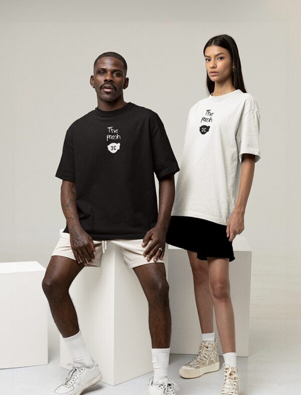 Mockup of a man and a woman wearing 'The Pooch World Tour' tee with customizable sleeves at a studio.
